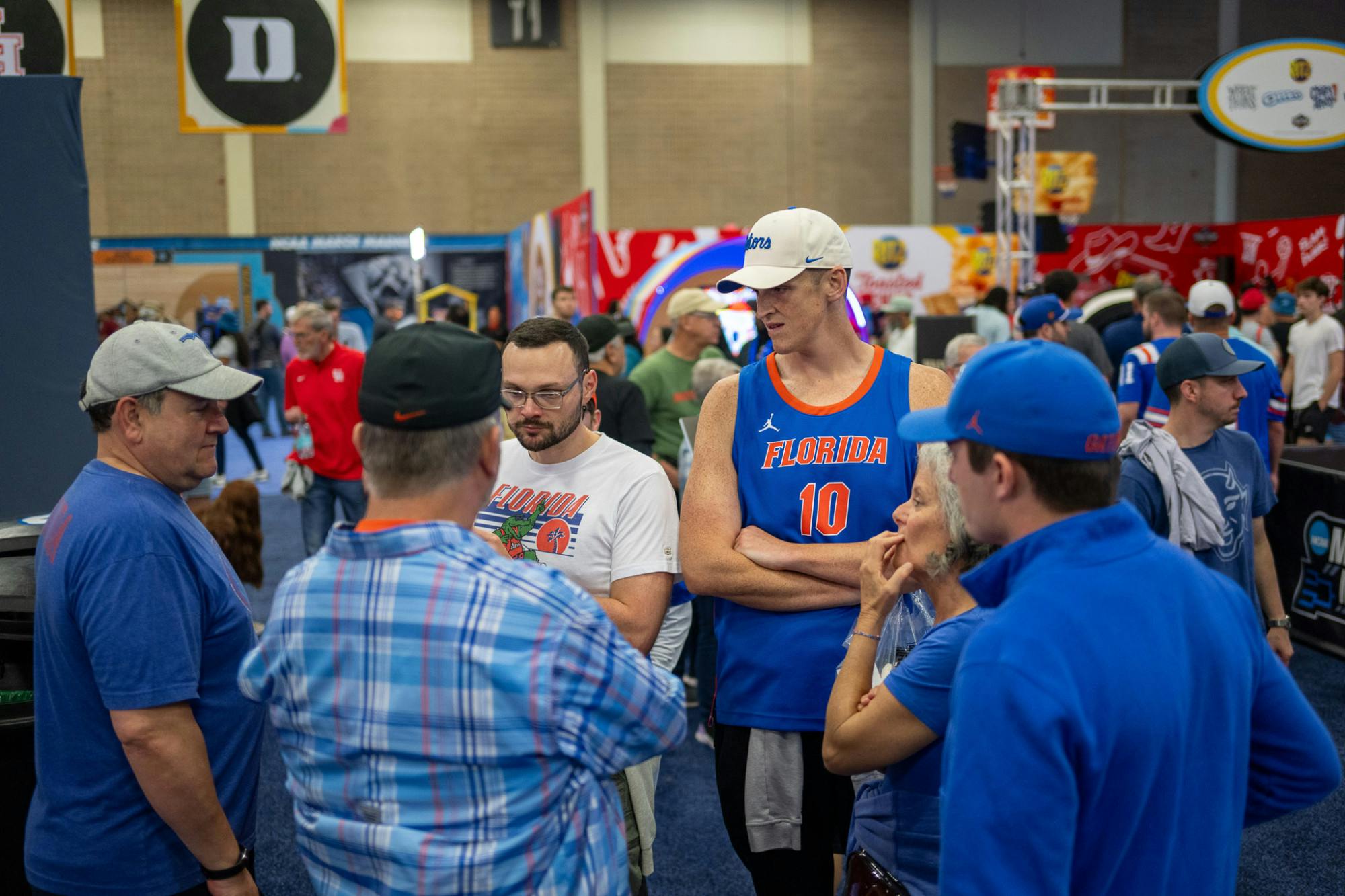 Florida Gators fans talk on the concourse of Capital One Fan Fest during Final Four weekend in San Antonio, Texas, on Saturday, April 5, 2025.