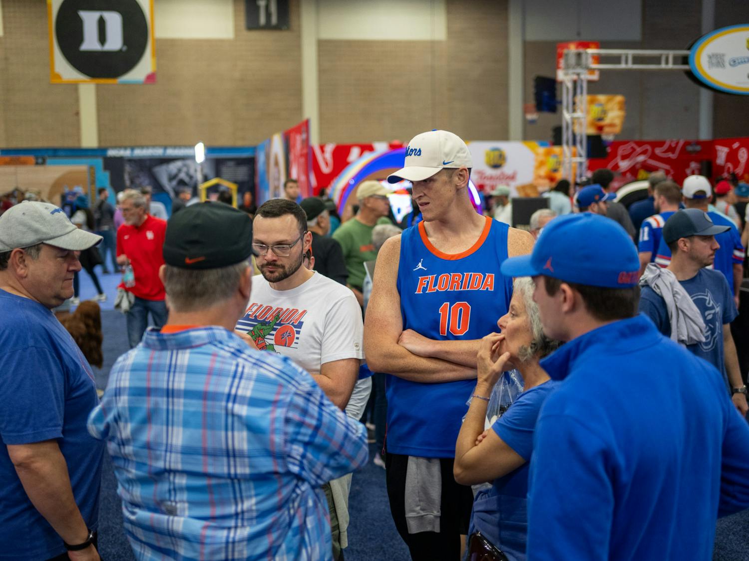 Florida Gators fans talk on the concourse of Capital One Fan Fest during Final Four weekend in San Antonio, Texas, on Saturday, April 5, 2025.