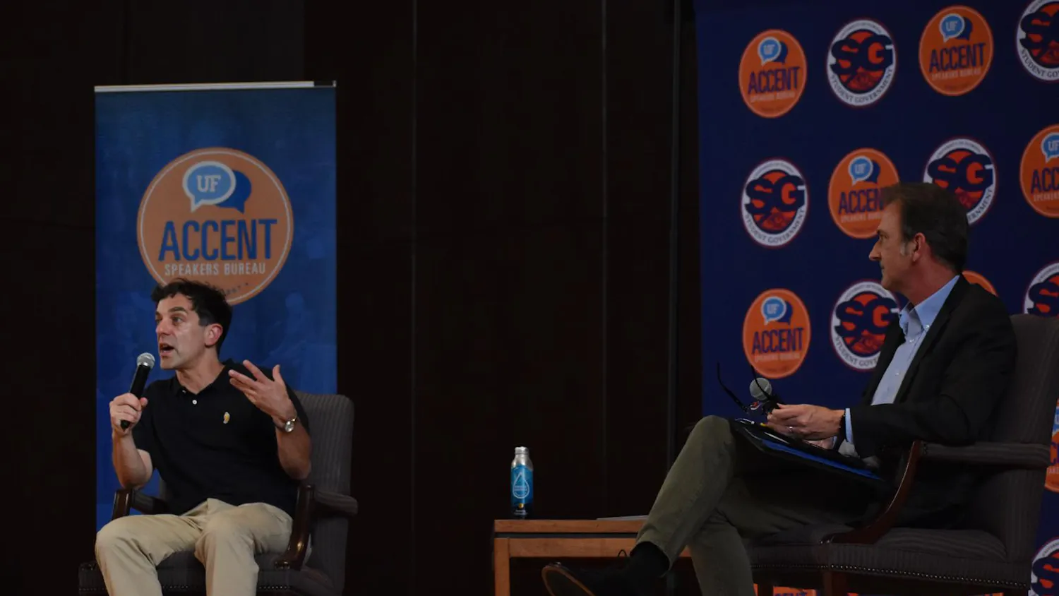 B.J. Novak (left), best known for his work on "The Office," speaks at the University Auditorium in Gainesville, Fla., on June 29, 2026. The conversation was moderated by Houston Wells (right).