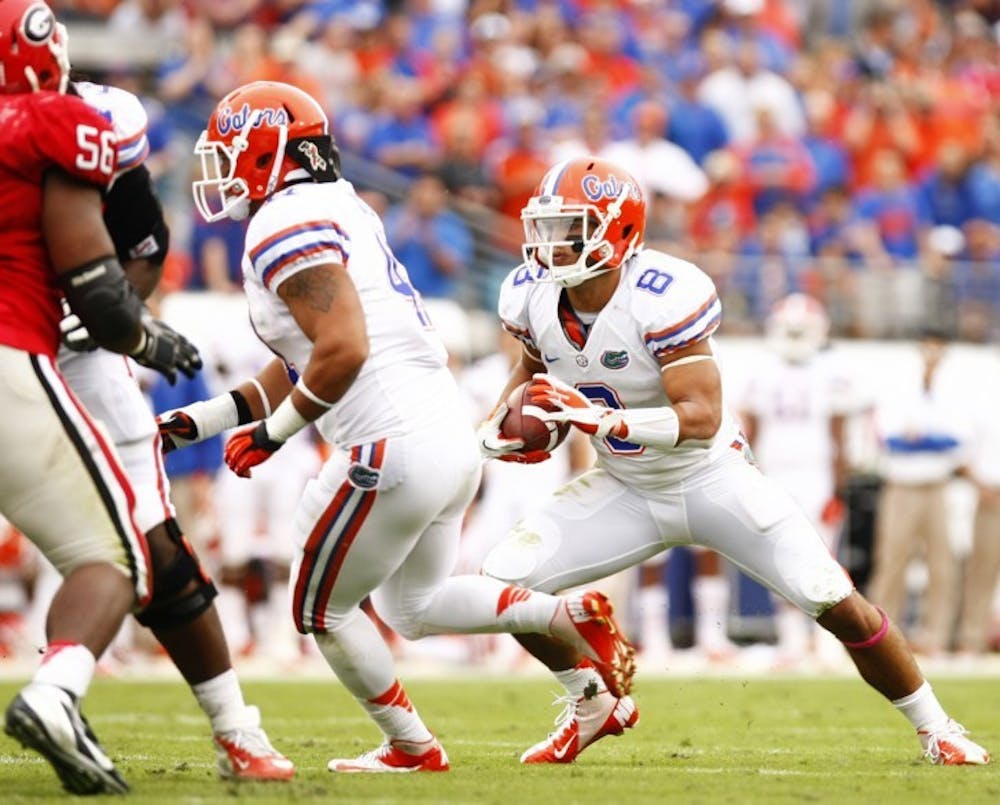 <p>Trey Burton (8) runs after a taking a direct snap in the wildcat formation during Florida’s 17-9 loss to Georgia on Saturday at EverBank Field in Jacksonville.</p>