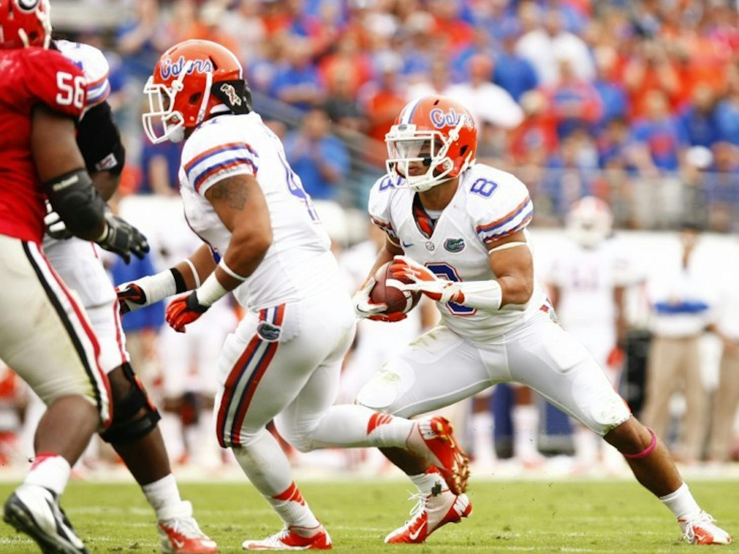 Trey Burton (8) runs after a taking a direct snap in the wildcat formation during Florida’s 17-9 loss to Georgia on Saturday at EverBank Field in Jacksonville.