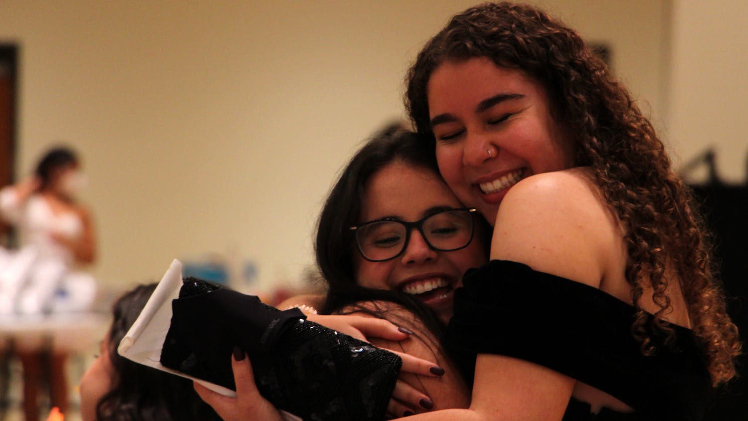 Daniella Duarte (left), 20, UF finance sophomore, receives a hug from her friend Gabriella Barreras (right), 20, UF advertising junior, during the masquerade ball in the Rion Ballroom at the Reitz Union on Thursday, Sept. 16, 2021. 