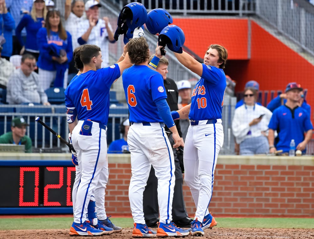 Florida infielder Colby Shelton (10) celebrates with infielder Cade Kurland (4) and infielder/outfielder Bobby Boser (6) after a home run as the Florida Gators face the Dayton Flyers on Saturday, Feb. 22, 2025, at Condron Family Ballpark in Gainesville, Fla.