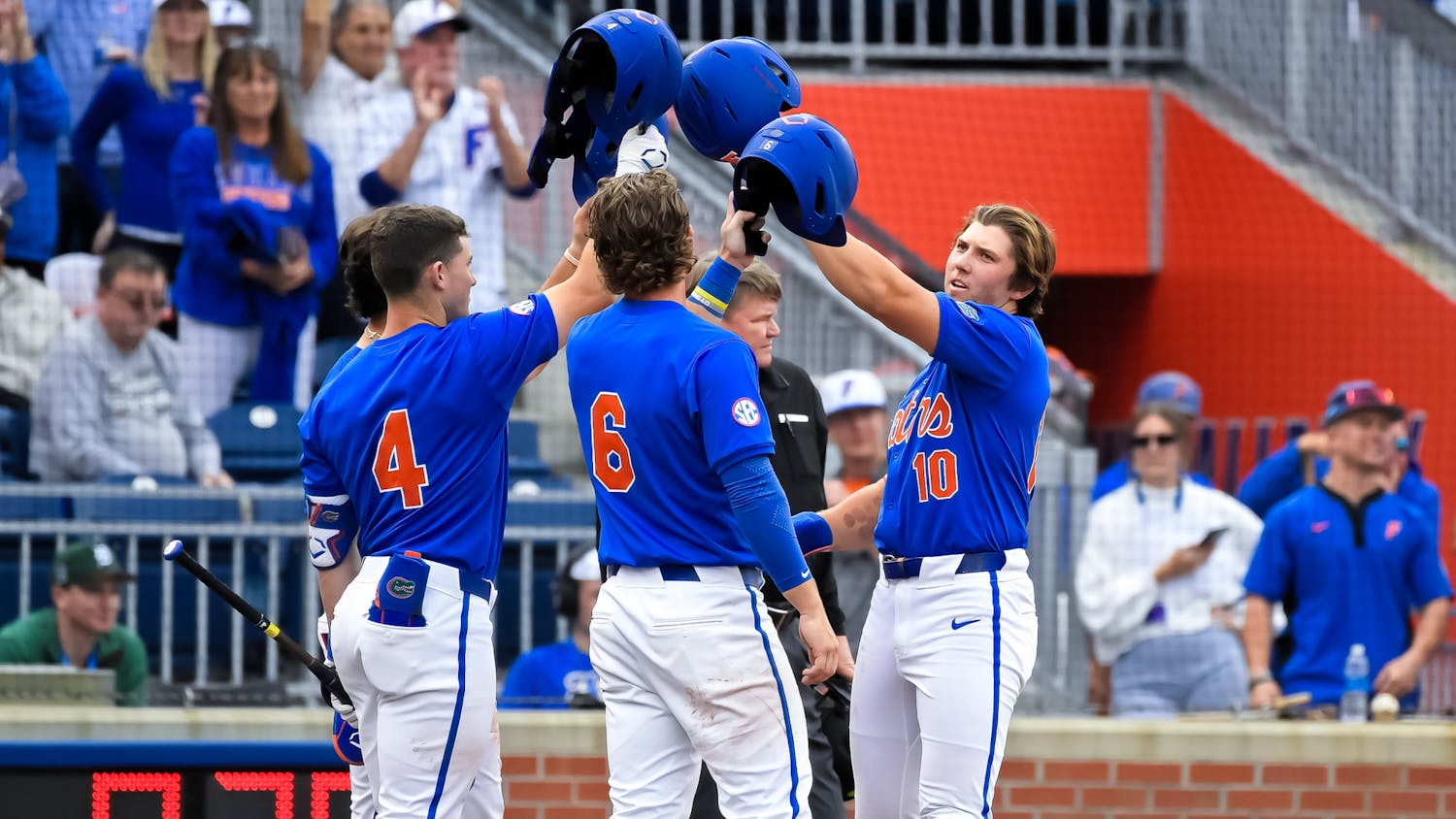 Florida infielder Colby Shelton (10) celebrates with infielder Cade Kurland (4) and infielder/outfielder Bobby Boser (6) after a home run as the Florida Gators face the Dayton Flyers on Saturday, Feb. 22, 2025, at Condron Family Ballpark in Gainesville, Fla.