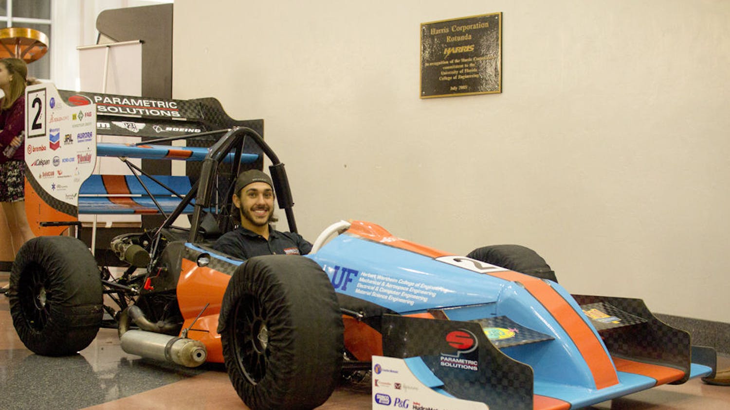 Gator Motorsports project manager David Kanner poses for a photo inside Gator Motorsports’ $90,000 Formula-style racecar, which will compete in at the Formula Society of Automotive Engineers Competition at the Michigan International Speedway in May.