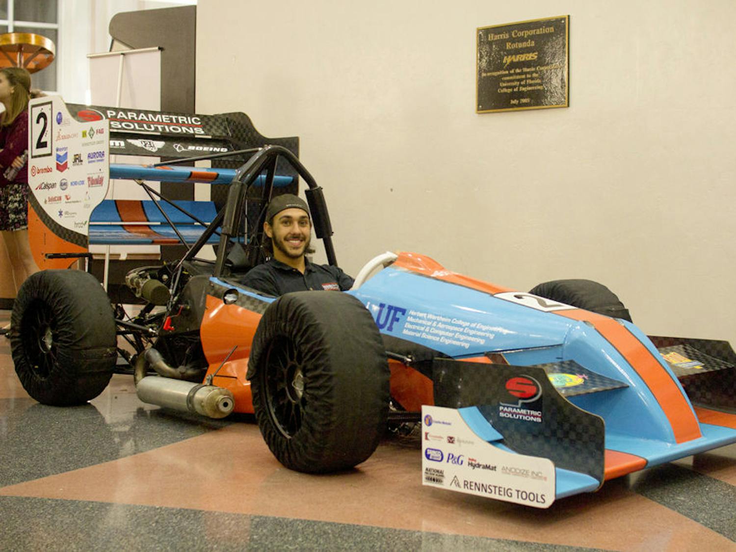 Gator Motorsports project manager David Kanner poses for a photo inside Gator Motorsports’ $90,000 Formula-style racecar, which will compete in at the Formula Society of Automotive Engineers Competition at the Michigan International Speedway in May.