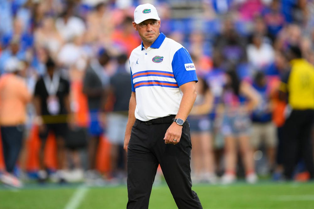 Florida head coach Jon Sumrall watches warmups before an NCAA college football game against FAU, Saturday, Sept. 5, 2026, in Gainesville, Fla.