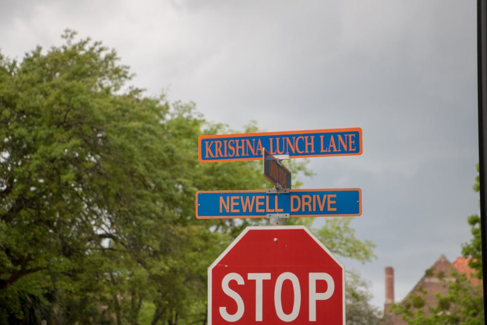 The orange and blue sign on the Plaza of the Americas reads "Krishna Lunch Lane."