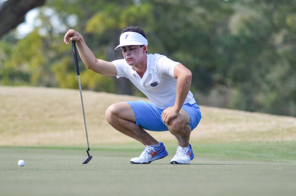 <p>Gordon Neal kneels during the 2016 Gator SunTrust Invitational at the Mark Bostick Golf Course.</p>
