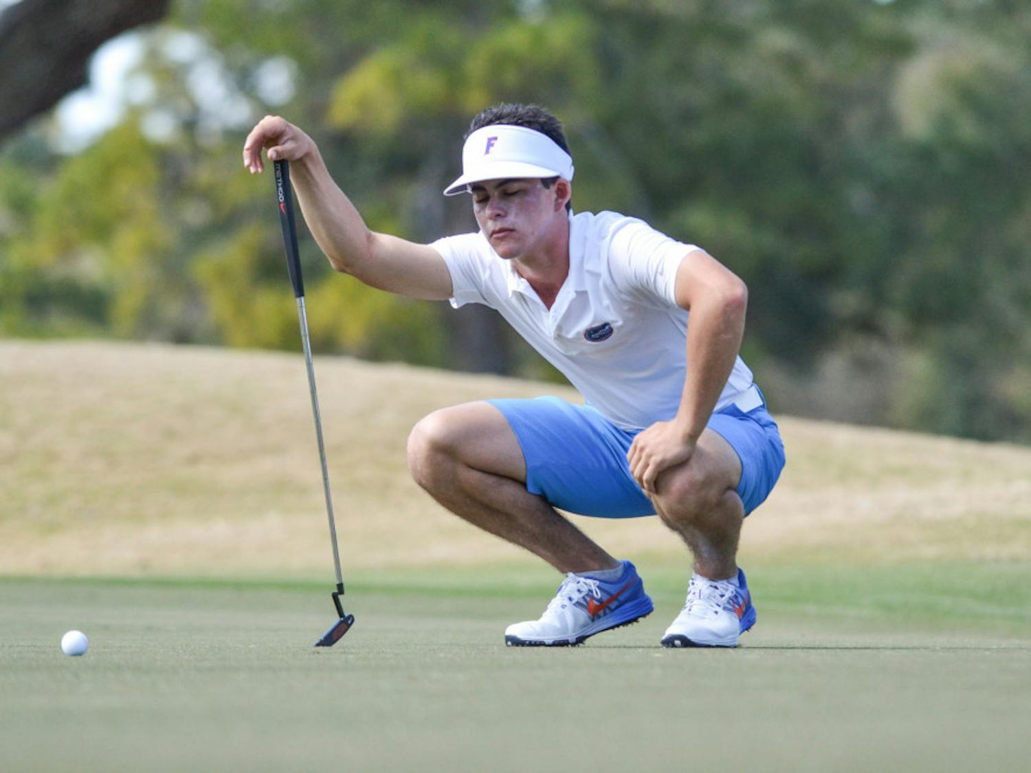 Gordon Neal kneels during the 2016 Gator SunTrust Invitational at the Mark Bostick Golf Course.