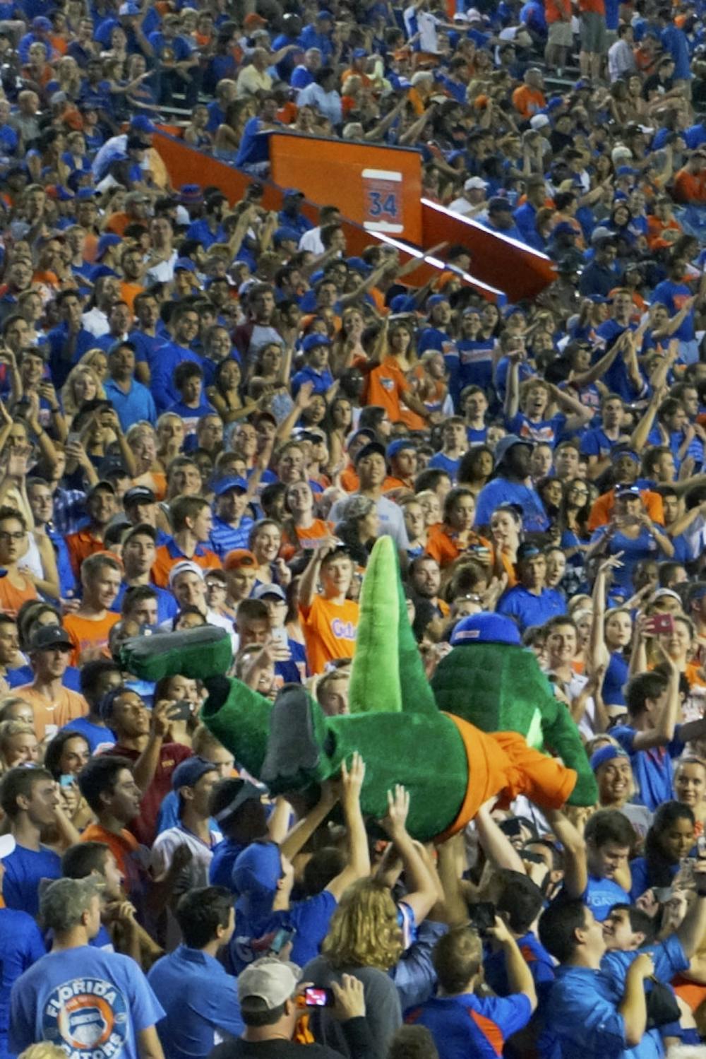 <p>Albert, one of UF's two mascots, surfs the crowd at the football game Sept. 5, 2015. Students and beach balls also traversed across the top of the fray.</p>
