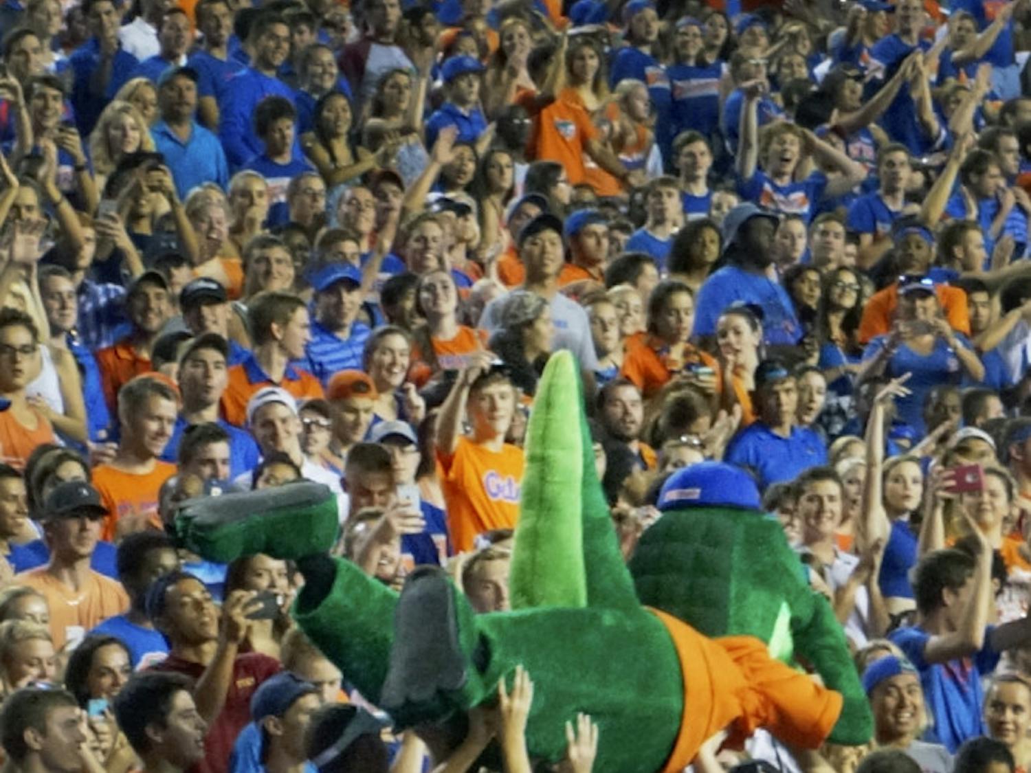 Albert, one of UF's two mascots, surfs the crowd at the football game Sept. 5, 2015. Students and beach balls also traversed across the top of the fray.