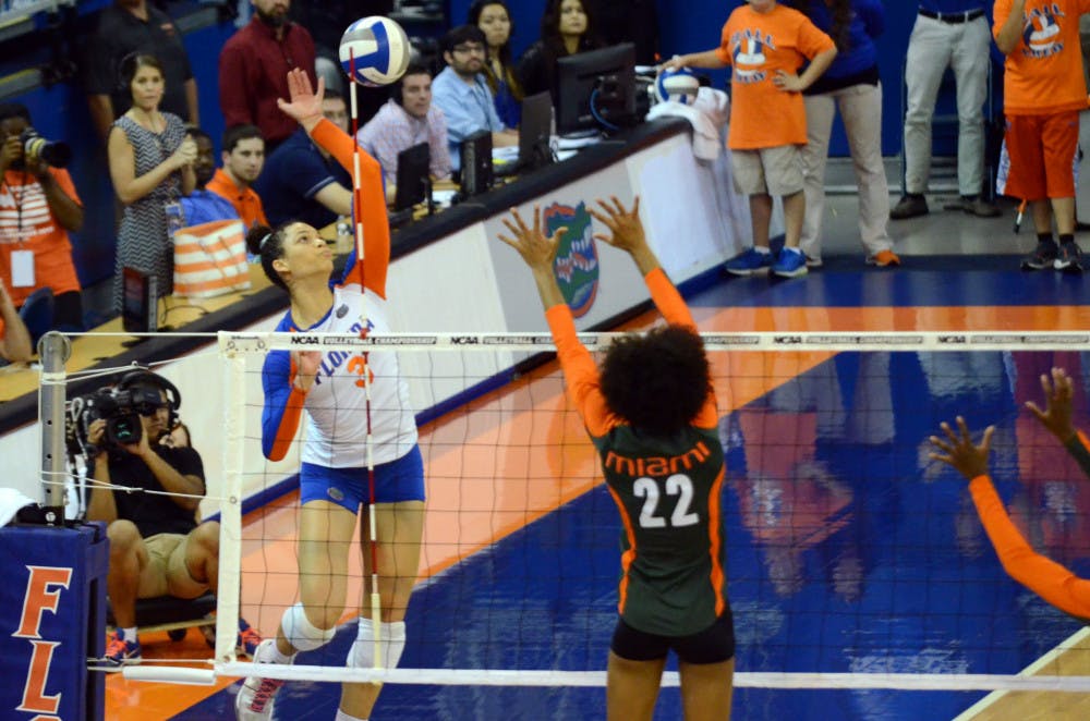 <p>Sophomore right-side hitter Alex Holston swings for a kill attempt during No. 8 seed Florida's 3-1 win against Miami in the second round of the 2014 NCAA Tournament on Dec. 6 in the O'Connell Center.</p>