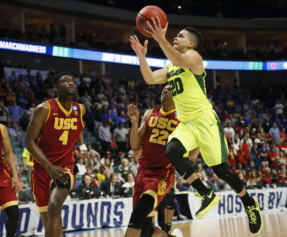 Baylor guard Manu Lecomte (20) goes up for a shot in front of Southern California forward Chimezie Metu (4) and guard De'Anthony Melton (22) during the second half of a second-round game in the NCAA men's college basketball tournament in Tulsa, Okla., Sunday, March 19, 2017. Baylor won 82-78. (AP Photo/Sue Ogrocki)