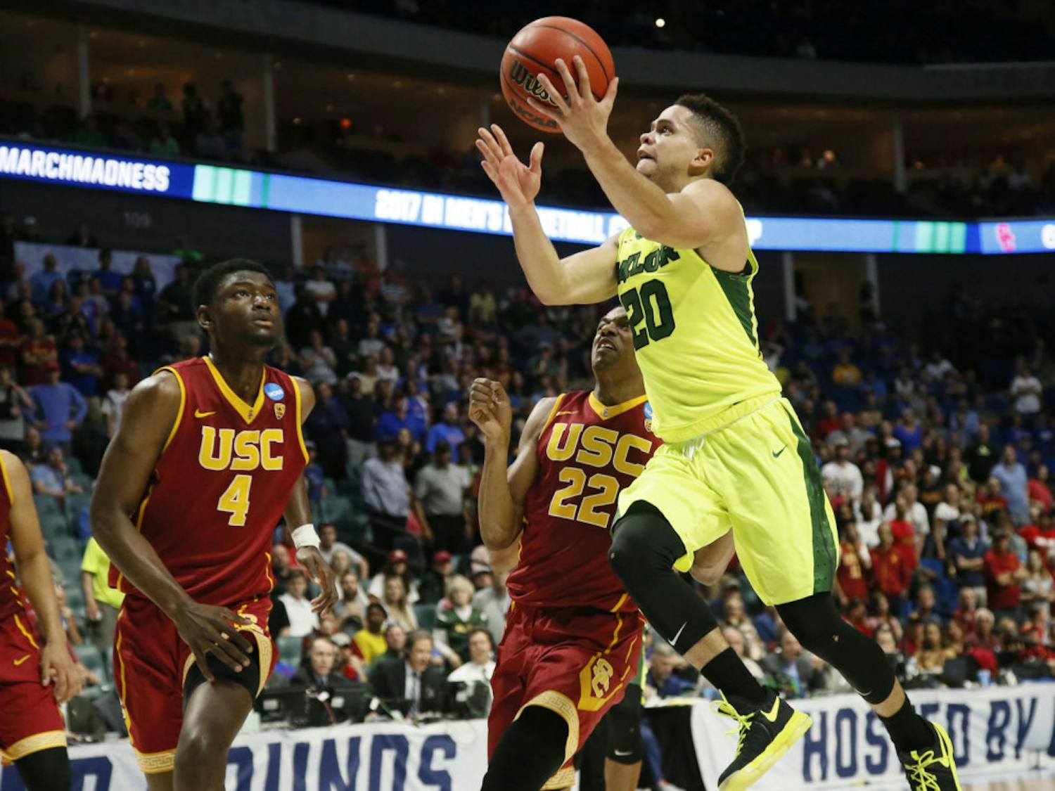 Baylor guard Manu Lecomte (20) goes up for a shot in front of Southern California forward Chimezie Metu (4) and guard De'Anthony Melton (22) during the second half of a second-round game in the NCAA men's college basketball tournament in Tulsa, Okla., Sunday, March 19, 2017. Baylor won 82-78. (AP Photo/Sue Ogrocki)