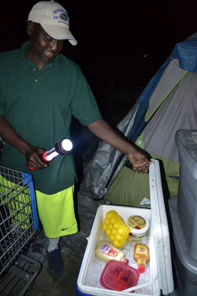 Dignity Village resident Rupert Heard, 55, from Toledo, Ohio, uses a cooler to keep perishable items from going bad, and plastic bins to store unrefrigerated items. He uses a grill to cook for himself and a few neighbors in his camp.
&nbsp;