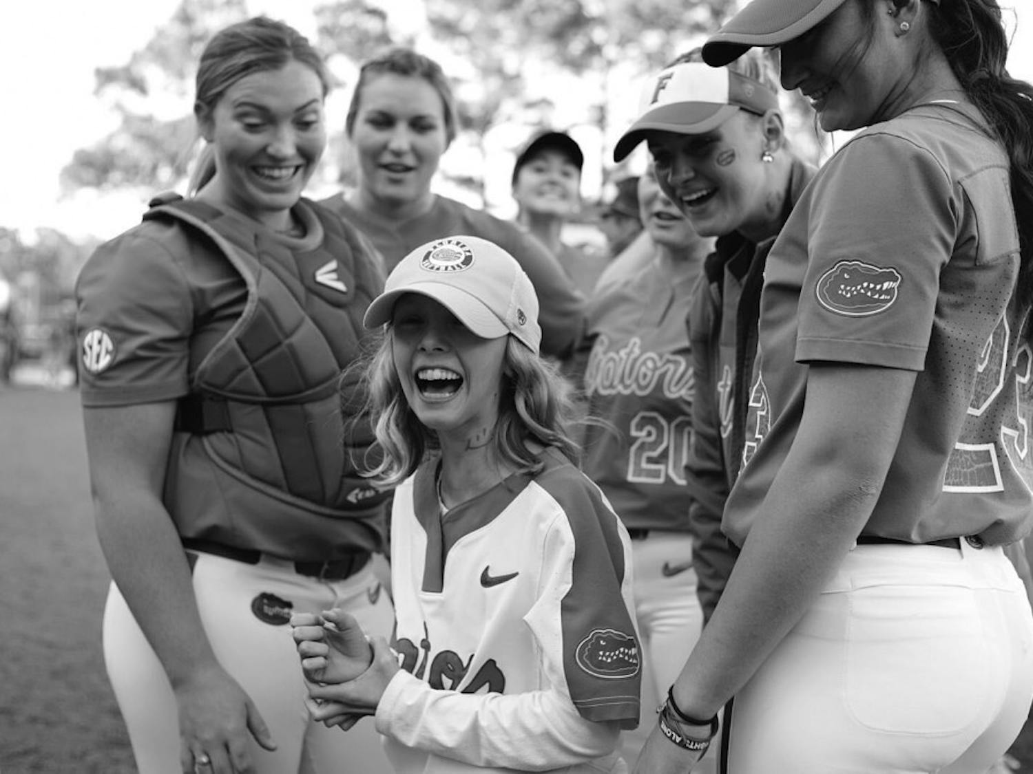 Hartley interacts with her Florida teammates ahead of UF's matchup with Florida State on April 3. Hartley, her teammates and the Seminoles all drew smiley faces on their necks to replicate that of Hayden Stone, an member of Florida State's team adopted through the Friends of Jaclyn. Hayden is now cancer free!