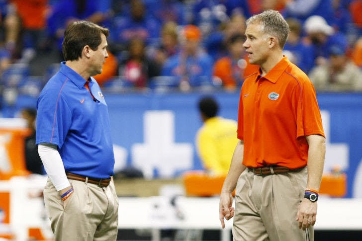 Defensive coordinator D.J. Durkin (right) speaks to coach Will Muschamp before Florida’s 33-23 loss to Louisville on Jan. 2 in the Sugar Bowl at the Superdome in New Orleans.
