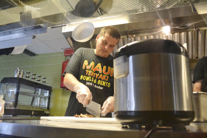 Gainesville native and Maui Grill manager Justin Amerson, 29, makes the Classic Chicken Bowl on Wednesday evening. The new restaurant opened April 21, replacing Corner - Latin Confusion.
&nbsp;