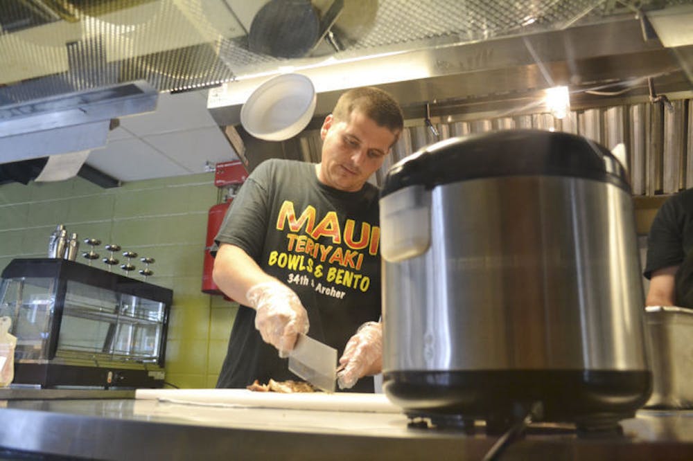 <p>Gainesville native and Maui Grill manager Justin Amerson, 29, makes the Classic Chicken Bowl on Wednesday evening. The new restaurant opened April 21, replacing Corner - Latin Confusion.</p>
<div>&nbsp;</div>