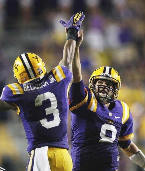 LSU junior quarterback Zach Mettenberger (8) and sophomore wide receiver Odell Beckham (3) congratulate each other after Mettenberger threw Beckham a 53-yard touchdown pass in the second half against Towson on Saturday. The No. 4 Tigers visit the No. 10 Florida Gators this weekend in Ben Hill Griffin Stadium. LSU fumbled five times last week.