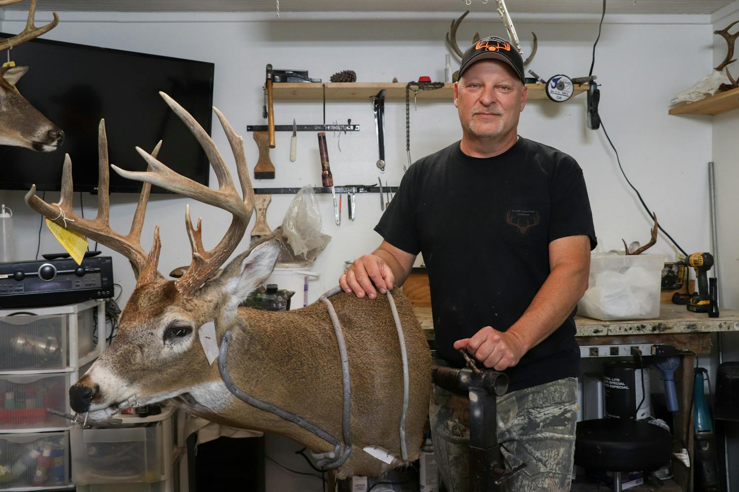 Jack Patton, 54, displays a taxidermy deer in his studio located in Steinhatchee, Florida, on Saturday, Sept. 30, 2023.