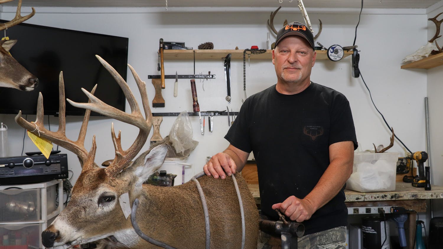Jack Patton, 54, displays a taxidermy deer in his studio located in Steinhatchee, Florida, on Saturday, Sept. 30, 2023.