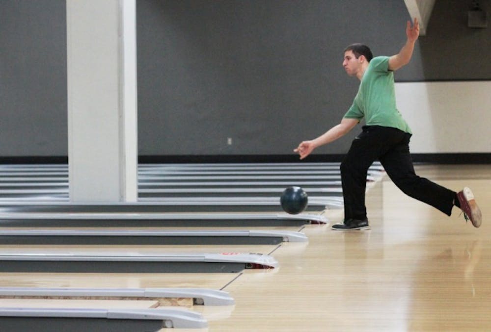 <p>Finance junior Christopher Howard, 21, bowls in the Reitz Union Game Room on Monday night during the Back to School Bash event, which featured discounted bowling games for $2 per person.</p>