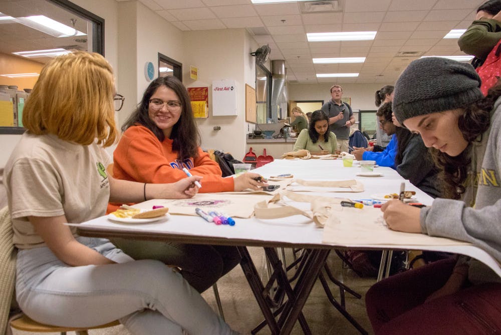 <p>UF students Diana Rodas, a zoology junior, Natalie Guzman, a public relations sophomore, and Patricia Lauzardo, a sociology senior, draw on canvas bags at the Reitz Union Arts &amp; Crafts Center Grand Reopening Extravaganza on Wednesday afternoon.</p>