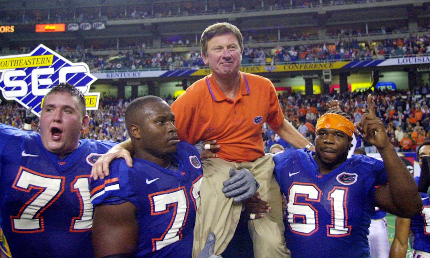 FILE - In this Dec. 2, 2000, file photo, Florida head coach Steve Spurrier is carried off the field by Mike Pearson (71), Kenyatta Walker (78) and Gerard Warren (61) after the Gators downed Auburn 28-6 in the SEC Championship NCAA college football game at the Georgia Dome in Atlanta. Florida is renaming its football field after former coach Steve Spurrier. The university's board of trustees approved the change Thursday, June 9,2016, making it Steve Spurrier-Florida Field at Ben Hill Griffin Stadium. (AP Photo/John Bazemore, File)