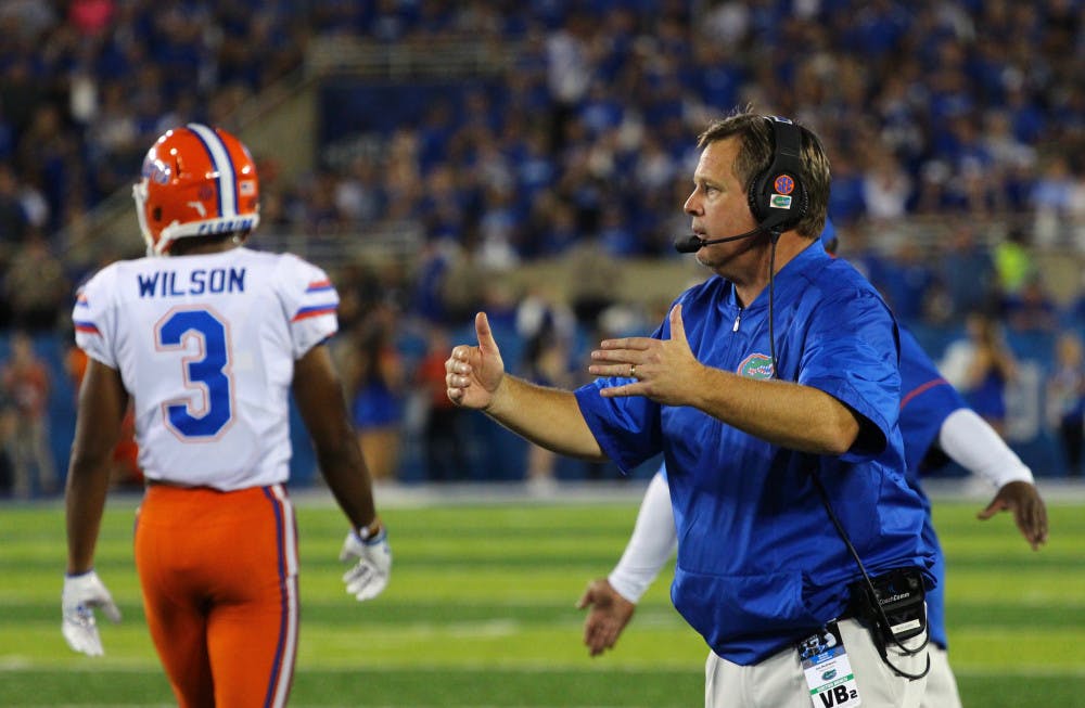 <p>UF coach Jim McElwain motions to the Gators defense during Florida's 28-27 win against Kentucky on Saturday at Kroger Field.</p>