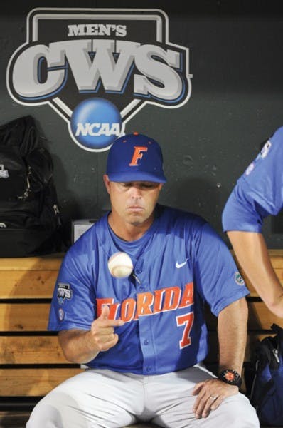 Florida coach Kevin O'Sullivan tosses a ball while sitting in the dugout after South Carolina beat Florida 5-2 in Game 2 of the NCAA baseball College World Series best-of-three finals, to win the championship, in Omaha, Neb., Tuesday, June 28, 2011.