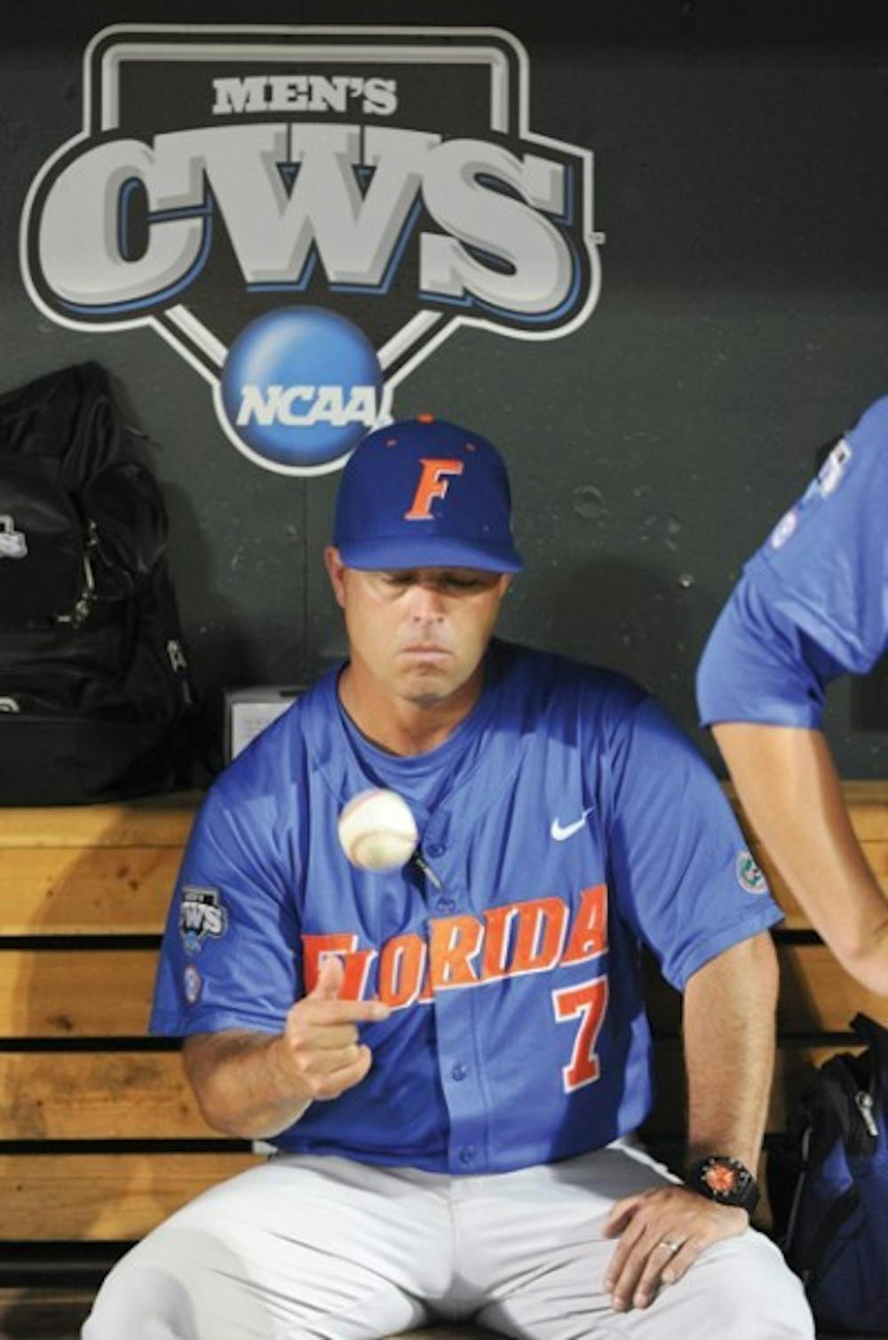 <p>Florida coach Kevin O'Sullivan tosses a ball while sitting in the dugout after South Carolina beat Florida 5-2 in Game 2 of the NCAA baseball College World Series best-of-three finals, to win the championship, in Omaha, Neb., Tuesday, June 28, 2011.</p>
