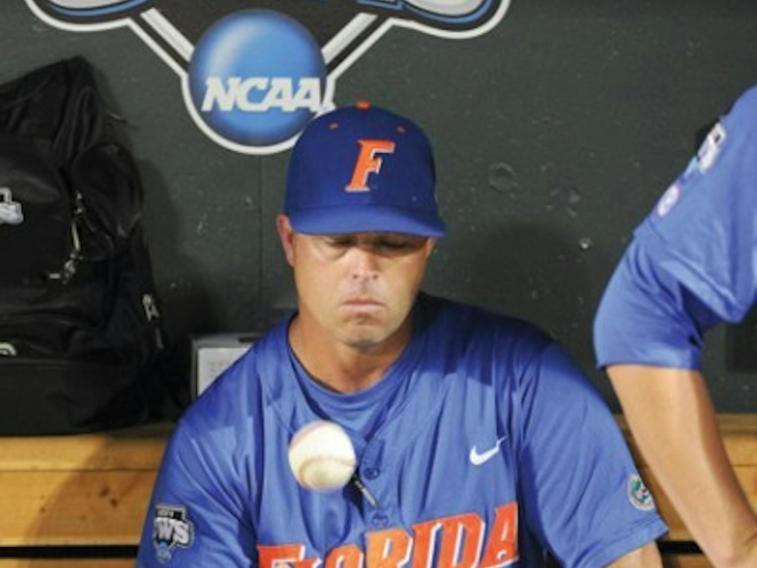 Florida coach Kevin O'Sullivan tosses a ball while sitting in the dugout after South Carolina beat Florida 5-2 in Game 2 of the NCAA baseball College World Series best-of-three finals, to win the championship, in Omaha, Neb., Tuesday, June 28, 2011.