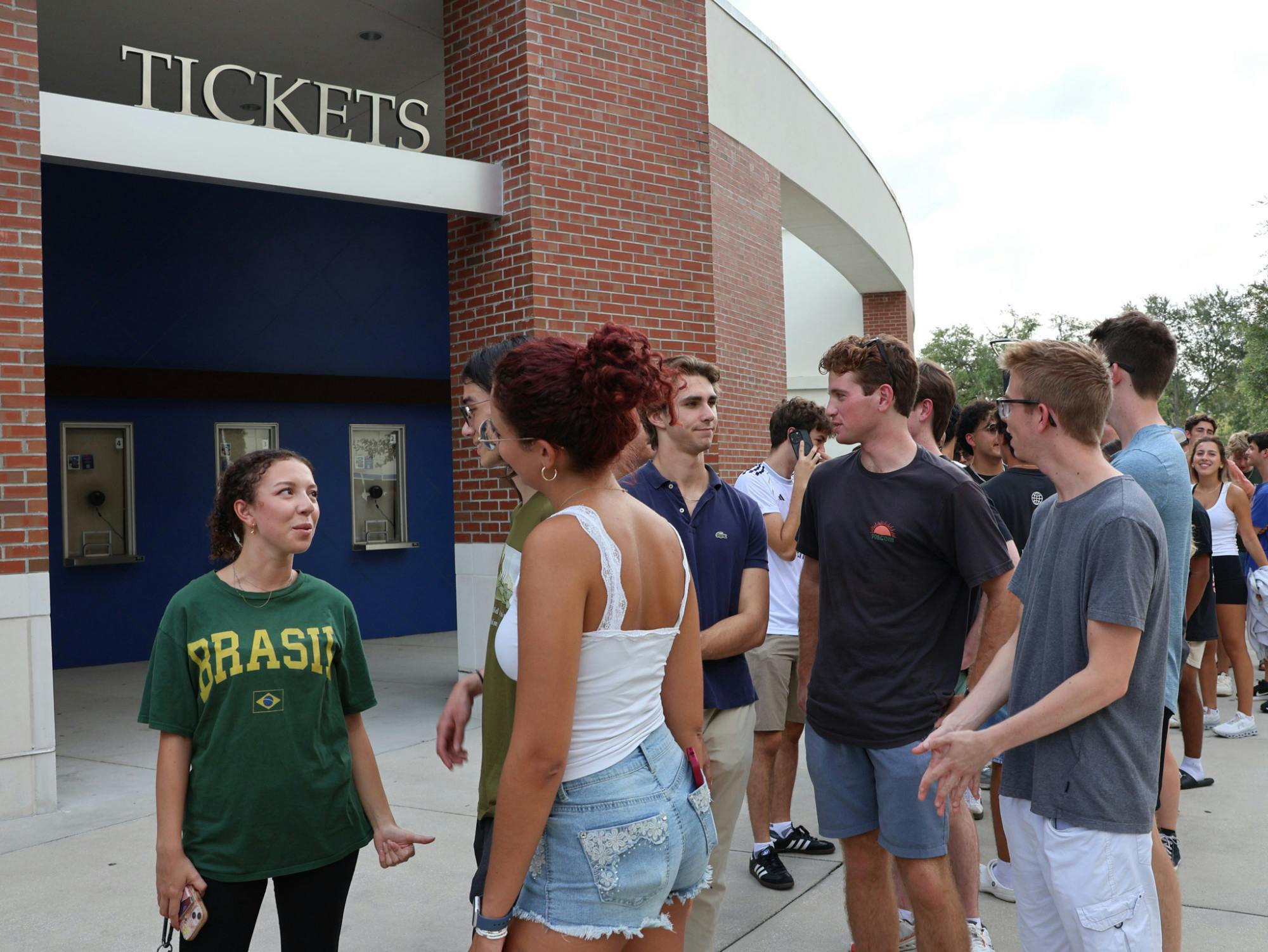 Students Victoria Morais, Joshua Nardone, and Chelsea Morales waiting in line for Student Government Accent Speakers Event featuring Bryan Cranston on Thursday, Aug. 21, 2025.