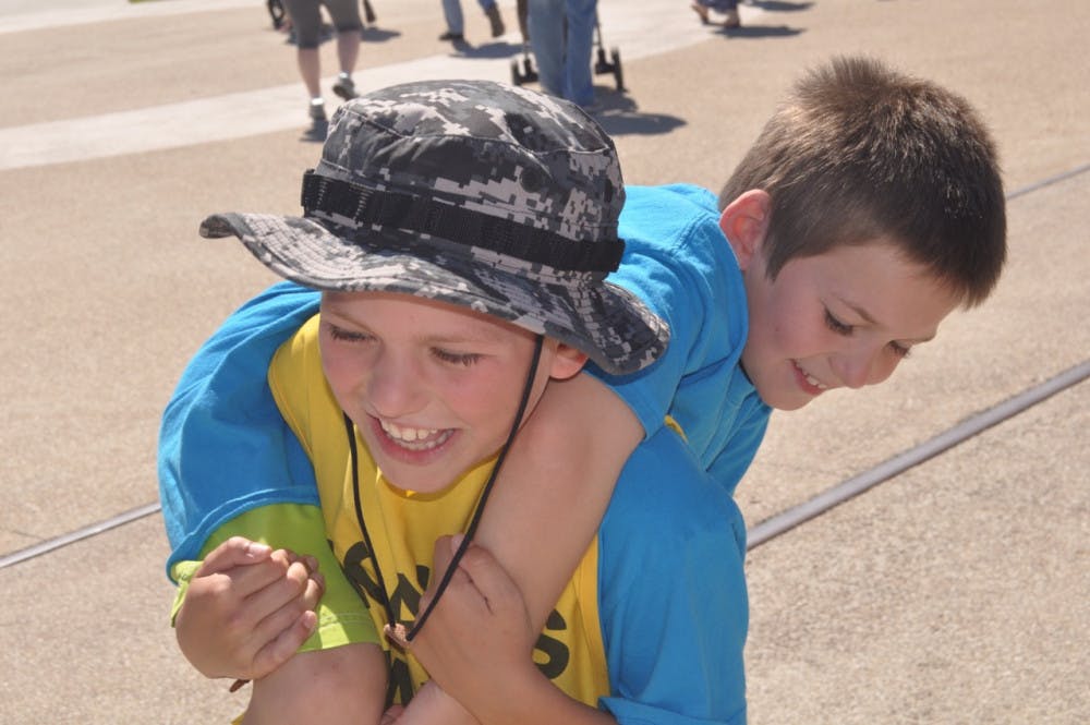 Noah Barnes, 10, carries his 8-year-old brother Jon at Active Streets Gainesville. Noah stopped in Gainesville on his yearlong march from Key West to Blaine, Washington, to promote diabetes awareness. 