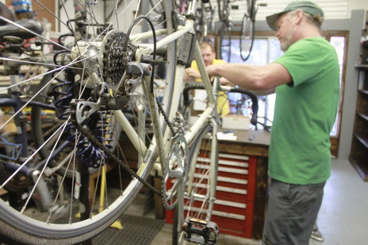 Mike Hetrick, 47, owner of Goodbike, works on a vintage Fuji road bike on Wednesday. The shop at 425 NW 13th St. opened its doors with a new name and new management on the Fourth of July.&nbsp;