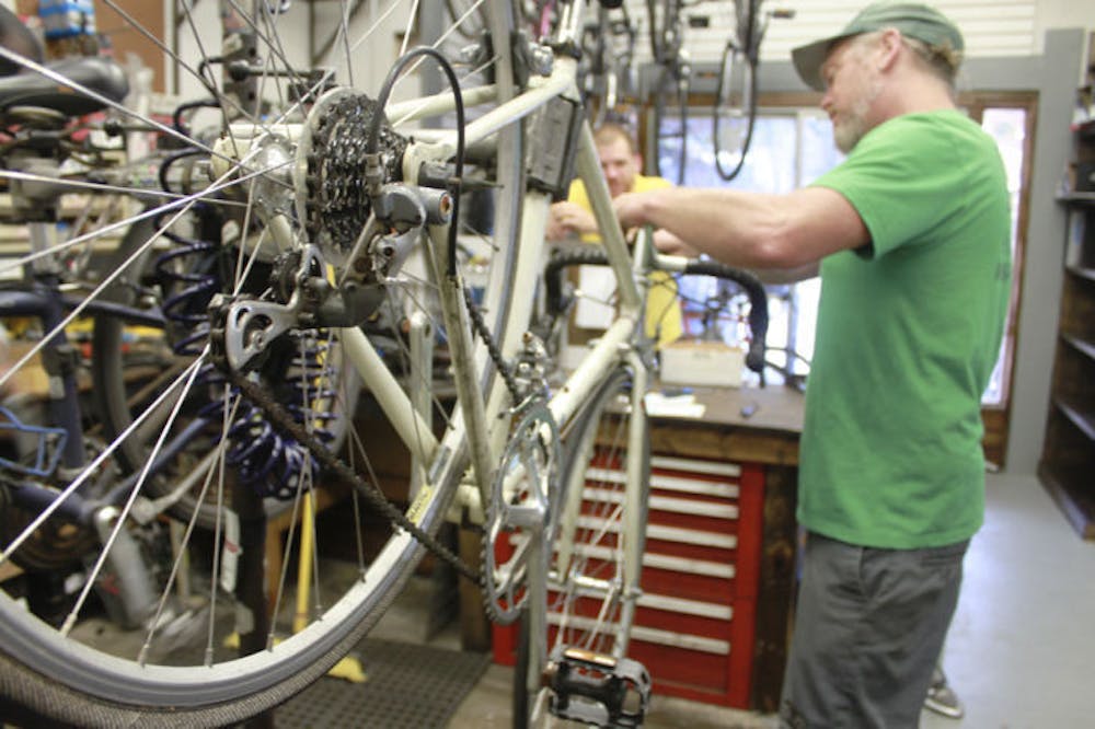 <p class="p1">Mike Hetrick, 47, owner of Goodbike, works on a vintage Fuji road bike on Wednesday. The shop at 425 NW 13th St. opened its doors with a new name and new management on the Fourth of July.&nbsp;</p>
