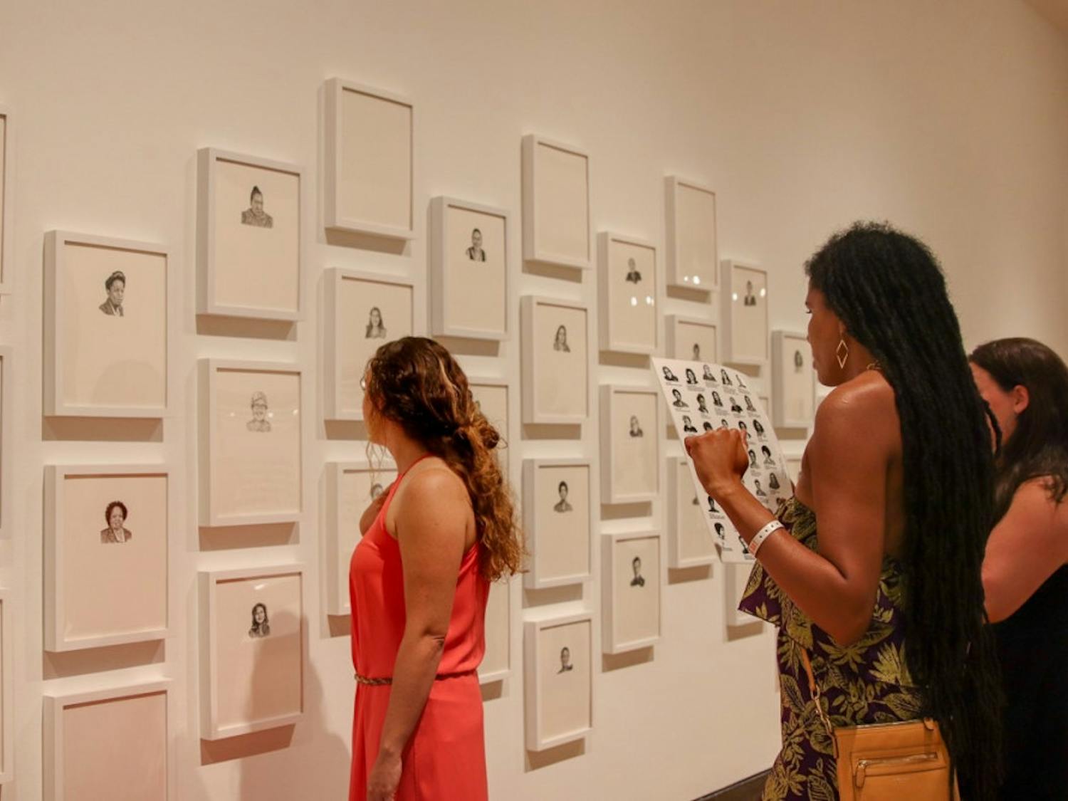 Visitors look at Lisa Iglesias’ exhibit, “groundbreaking,” at the Harn Museum of Art. She said she uses her artwork to deliver social justice themes. 