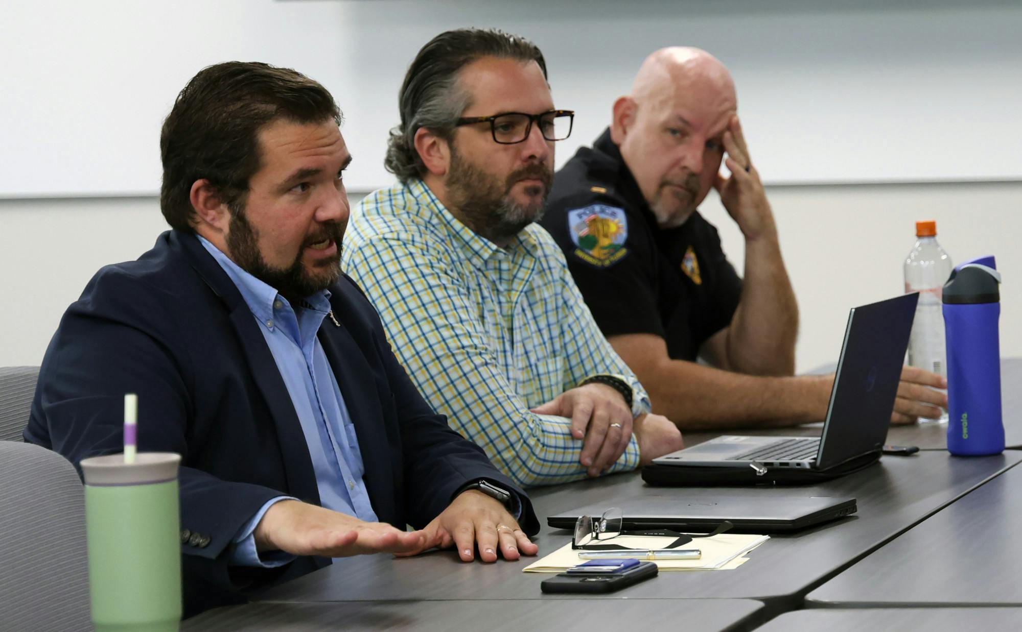 Patrick Keegan (far left), the University of Florida’s chief labor negotiator, discusses potential changes to the collective bargaining agreement before its signing later this week at the UF Police Department on Monday, July 14, 2025.