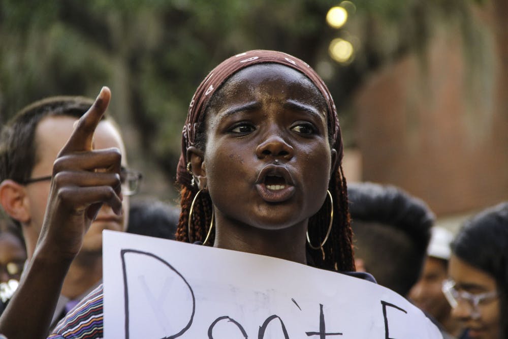 Jamie Douglas, an 18-year-old UF telecommunication sophomore, chants in solidarity with Iranian and Iraqi people at an anti-war demonstration on Turlington Plaza Wednesday afternoon.
