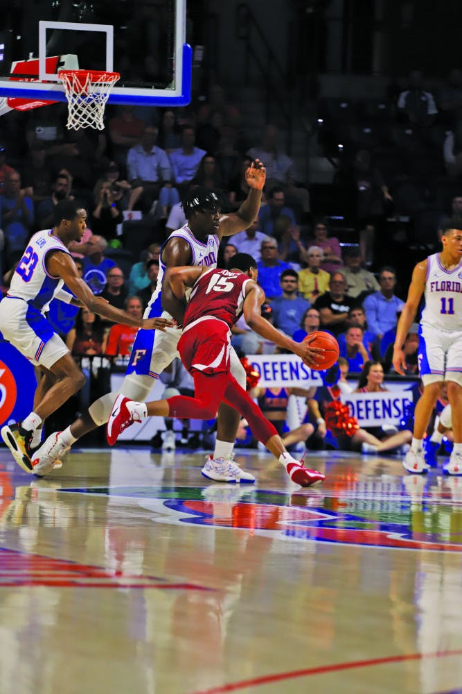 The Gators swarm Arkansas' Mason Jones.