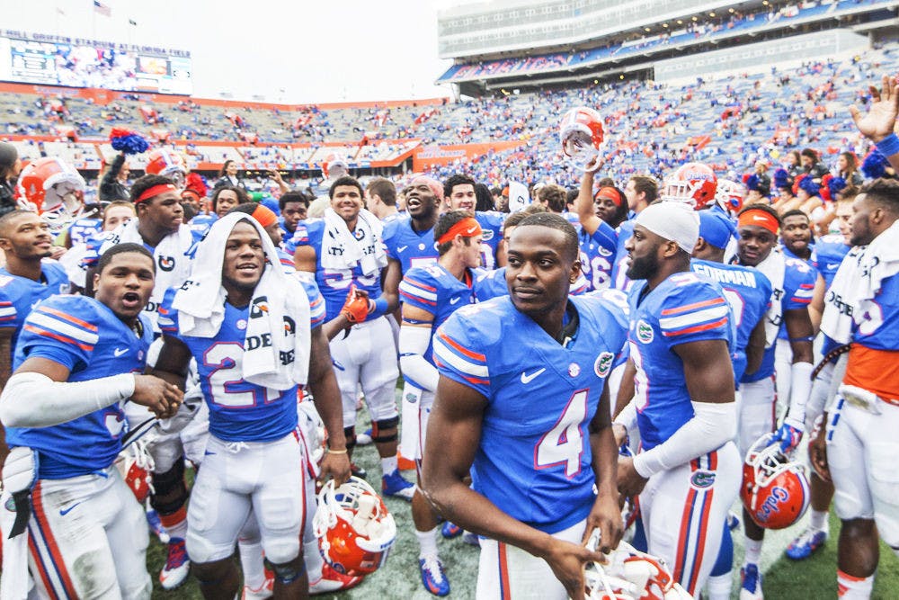 <p>UF players celebrate following Florida's 52-3 win against Eastern Kentucky on Saturday at Ben Hill Griffin Stadium.</p>
