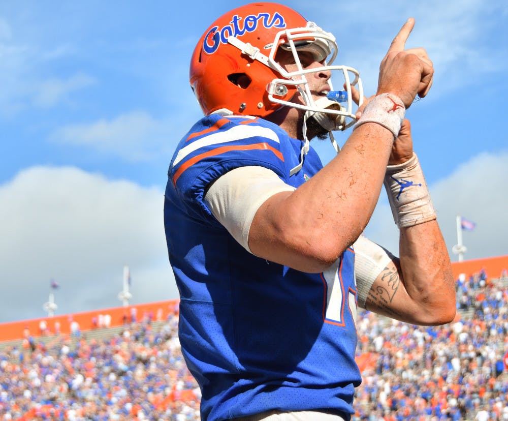 <p>Quarterback Feleipe Franks shushes the home crowd at The Swamp after his second rushing touchdown against South Carolina on Saturday. </p>