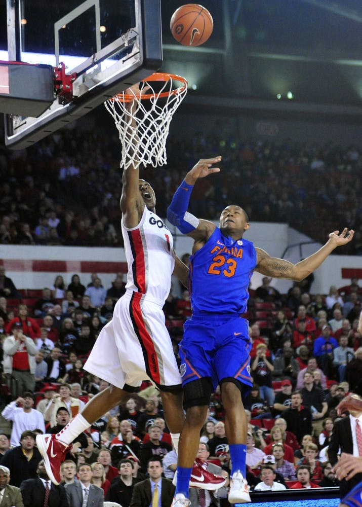 Georgia guard Kentavious Caldwell-Pope (1) shoots past Florida guard Bradley Beal (23) during the second half of Georgia's 76-62 win on Saturday. 