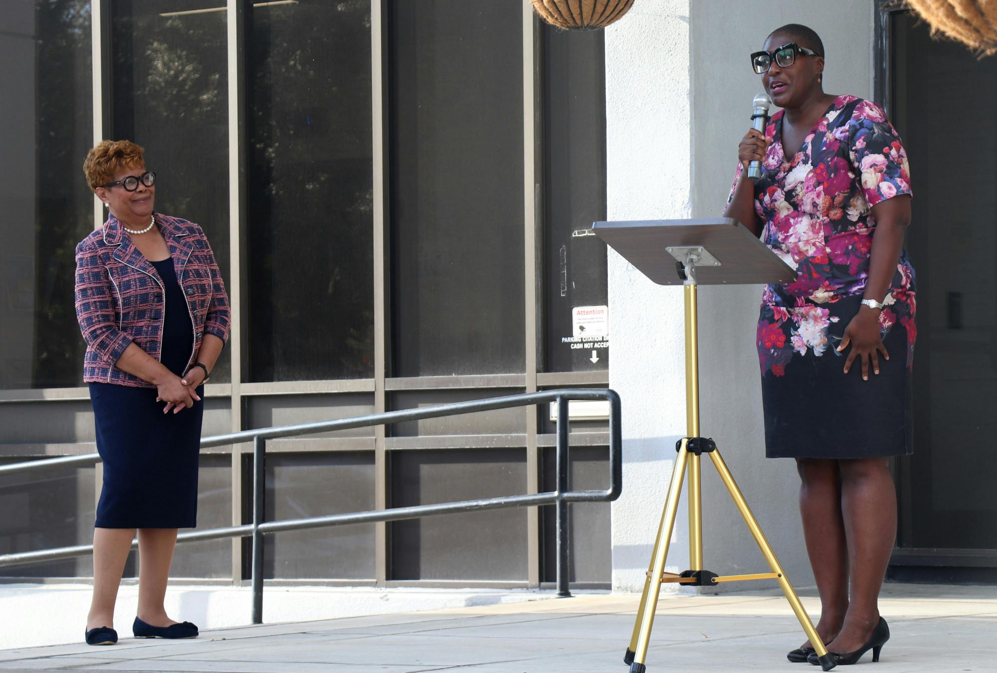 Cynthia Chestnut (left) listens to former Commissioner Gail Johnson (right) announce her endorsement of Chestnut's campaign on the steps of Gainesville City Hall on Monday, Sept. 27, 2021. 