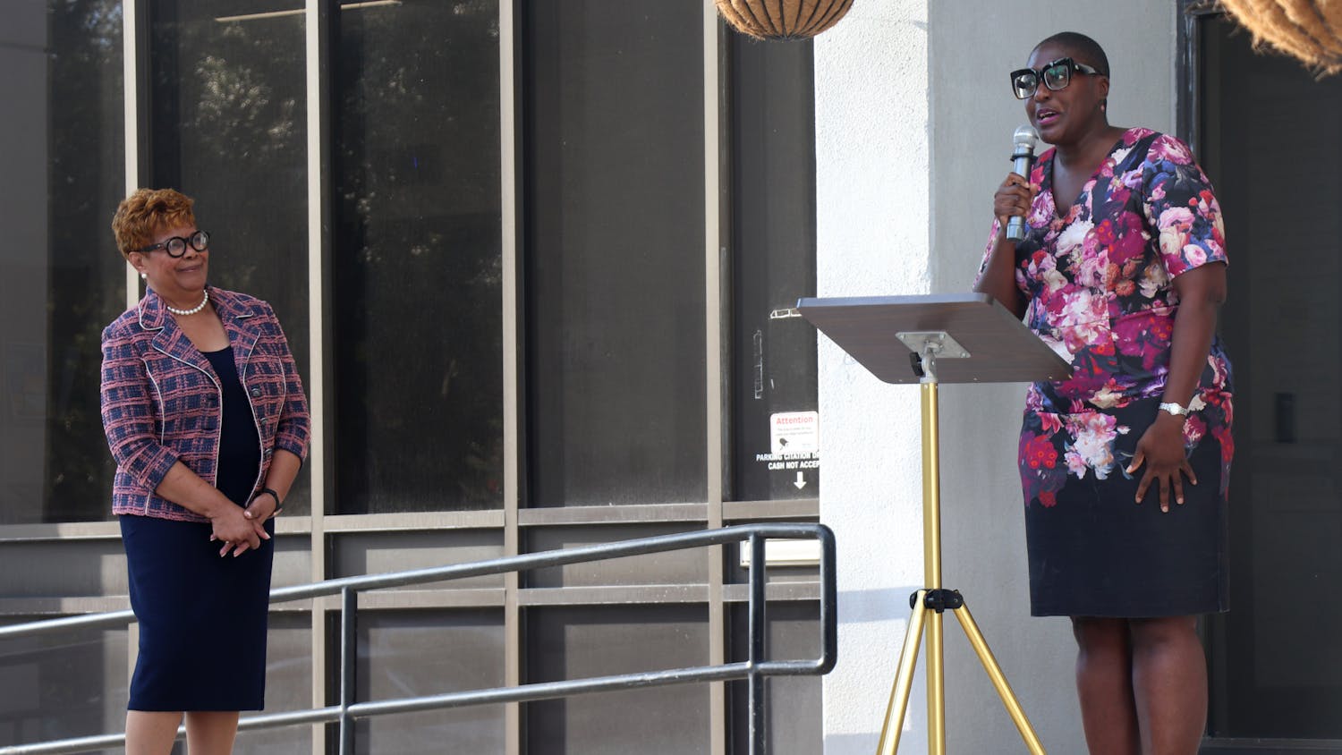 Cynthia Chestnut (left) listens to former Commissioner Gail Johnson (right) announce her endorsement of Chestnut's campaign on the steps of Gainesville City Hall on Monday, Sept. 27, 2021. 