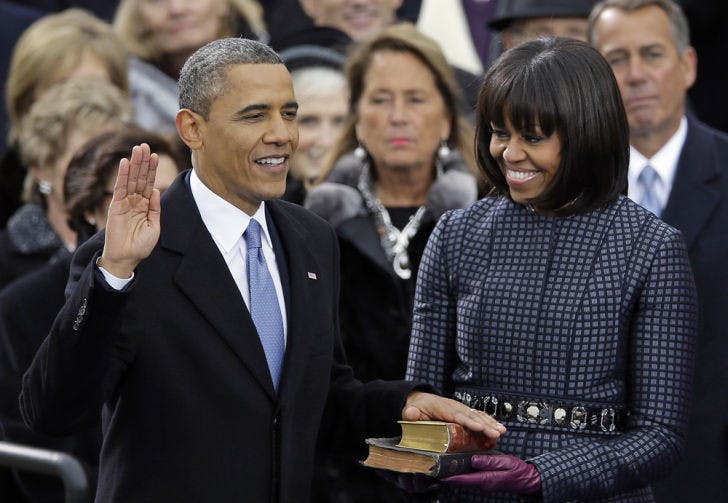 President Barack Obama receives the oath of office from Chief Justice John Roberts as first lady Michelle Obamas and his daughters Malia and Sasha look on at the ceremonial swearing-in at the U.S. Capitol during the 57th Presidential Inauguration in Washington, Monday, Jan. 21, 2013. (AP Photo/Carolyn Kaster)