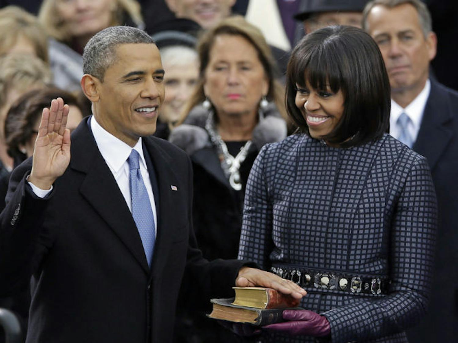 President Barack Obama receives the oath of office from Chief Justice John Roberts as first lady Michelle Obamas and his daughters Malia and Sasha look on at the ceremonial swearing-in at the U.S. Capitol during the 57th Presidential Inauguration in Washington, Monday, Jan. 21, 2013. (AP Photo/Carolyn Kaster)