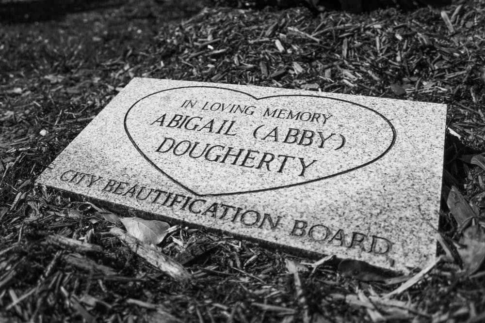 A close-up of the plaque that was made in honor of Abigail Dougherty. The plaque rests below the southern magnolia treeplanted for Dougherty on Thursday.